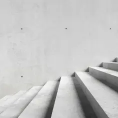 Minimalistyczne schody betonowe, idealne dla tych, którzy szukają, jak tanio wykończyć schody betonowe.